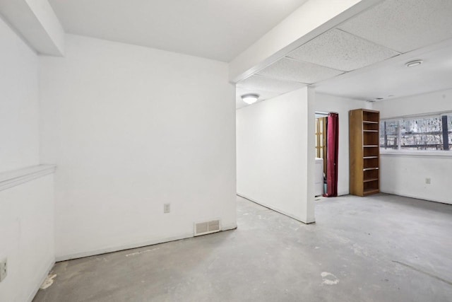 basement featuring a drop ceiling