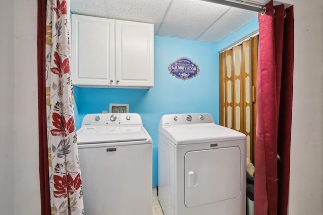 laundry room with cabinets and washing machine and clothes dryer