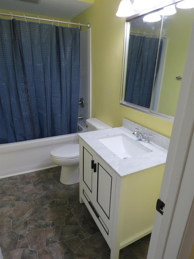 full bathroom with vanity, toilet, and shower / bath combo