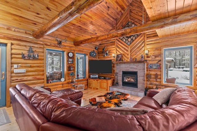 living room featuring beam ceiling, a tile fireplace, wooden ceiling, and light wood-type flooring