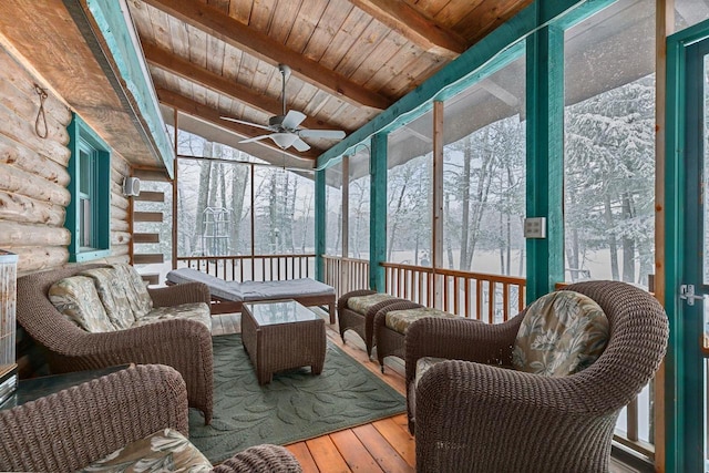 sunroom featuring ceiling fan, wooden ceiling, and beamed ceiling