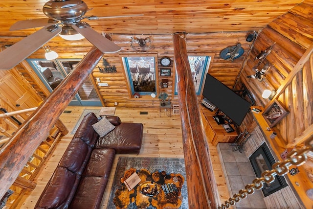 unfurnished living room with a tiled fireplace and ceiling fan