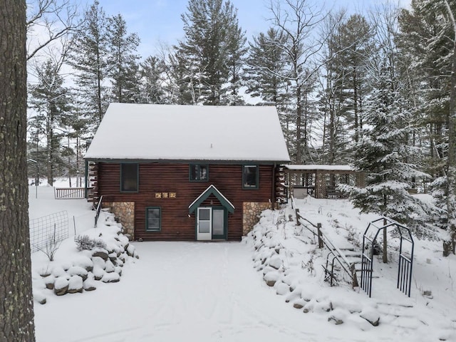 view of snow covered rear of property