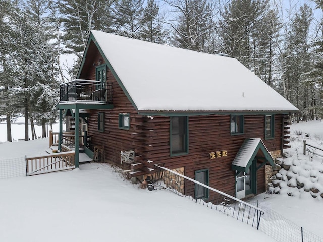 view of snow covered back of property