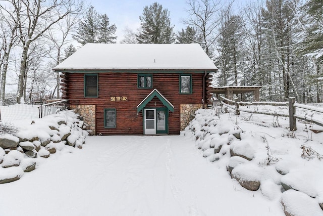 view of snow covered back of property