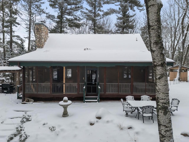 view of front facade with a sunroom