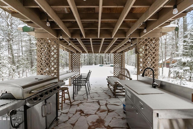 snow covered patio featuring grilling area