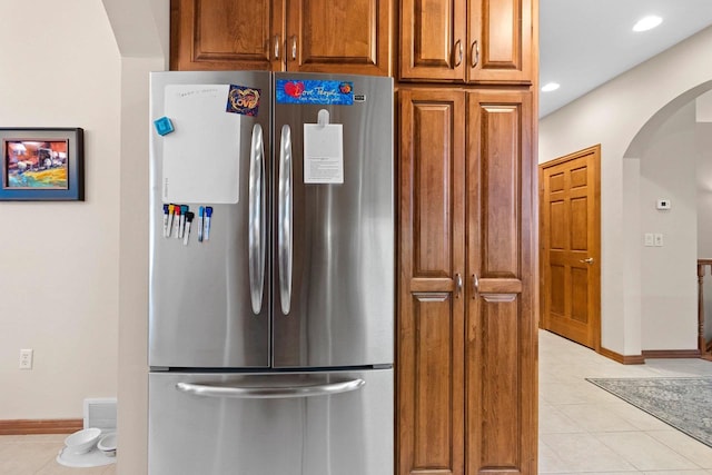 kitchen featuring stainless steel fridge and light tile patterned floors