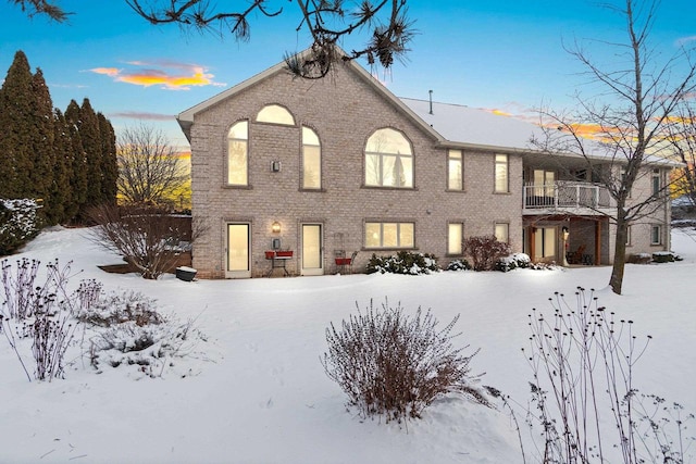 view of snow covered rear of property