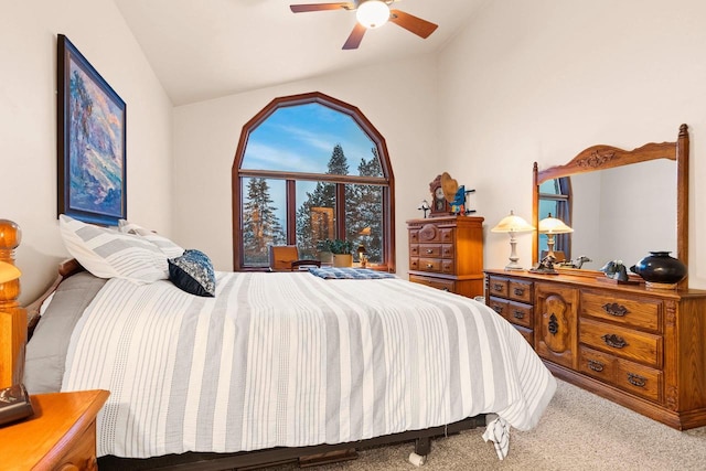 bedroom with vaulted ceiling, ceiling fan, and carpet flooring