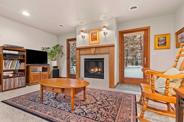 carpeted living room with a healthy amount of sunlight and a fireplace