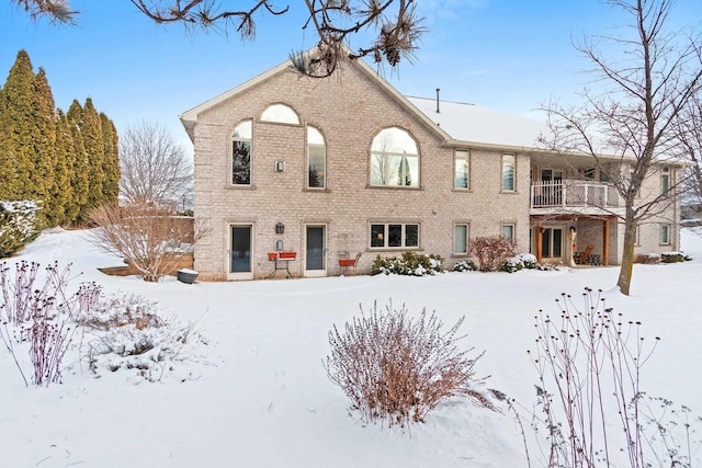 view of snow covered back of property