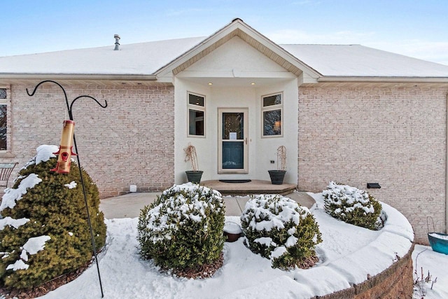 view of snow covered property entrance