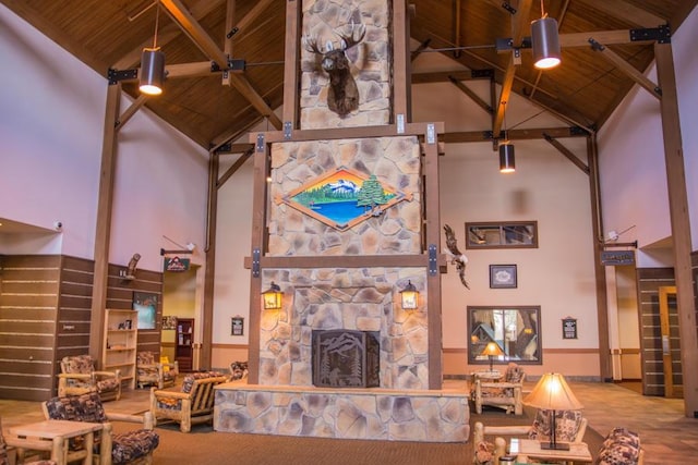 living room with wood ceiling, a fireplace, and high vaulted ceiling