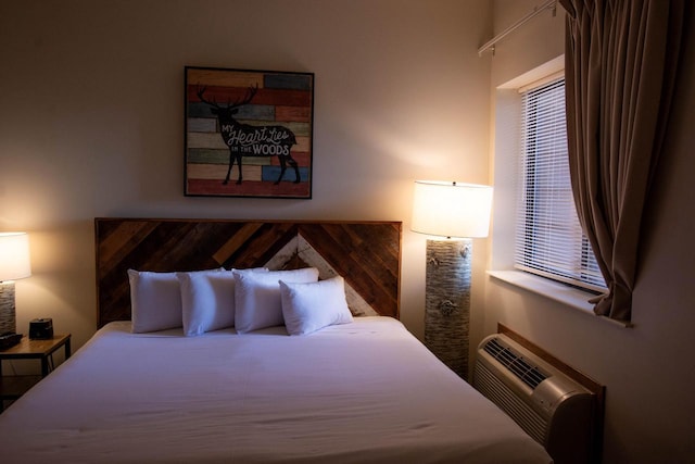 bedroom featuring an AC wall unit