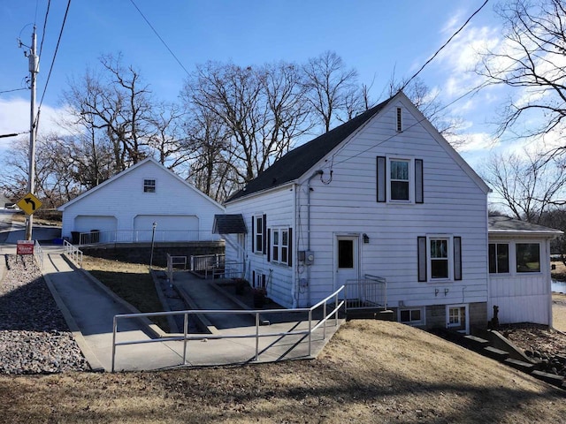 rear view of house with an outbuilding and a garage