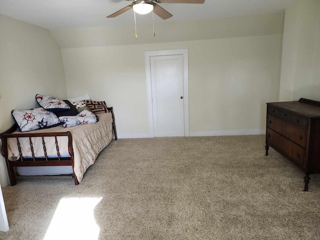 carpeted bedroom featuring lofted ceiling and ceiling fan