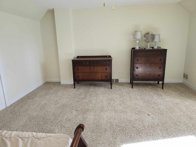 sitting room with lofted ceiling and light carpet