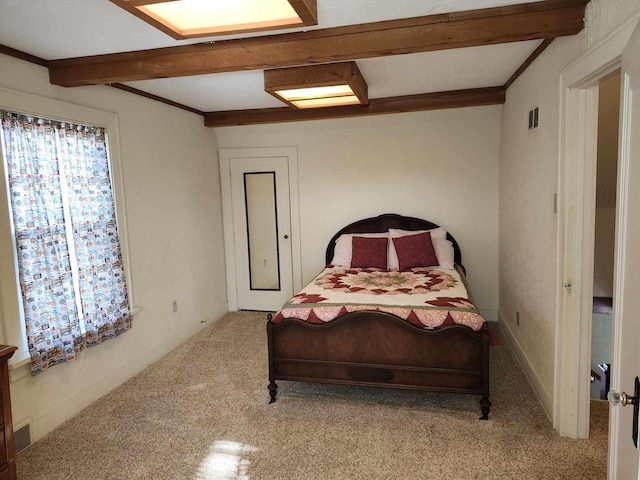 bedroom featuring beamed ceiling, crown molding, and light carpet