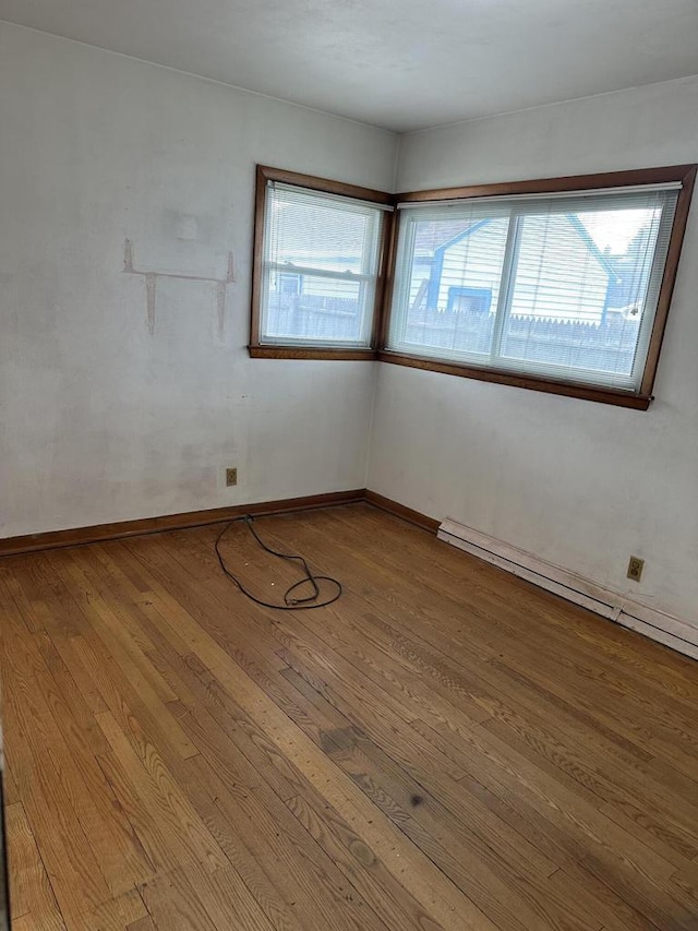 unfurnished room with wood-type flooring