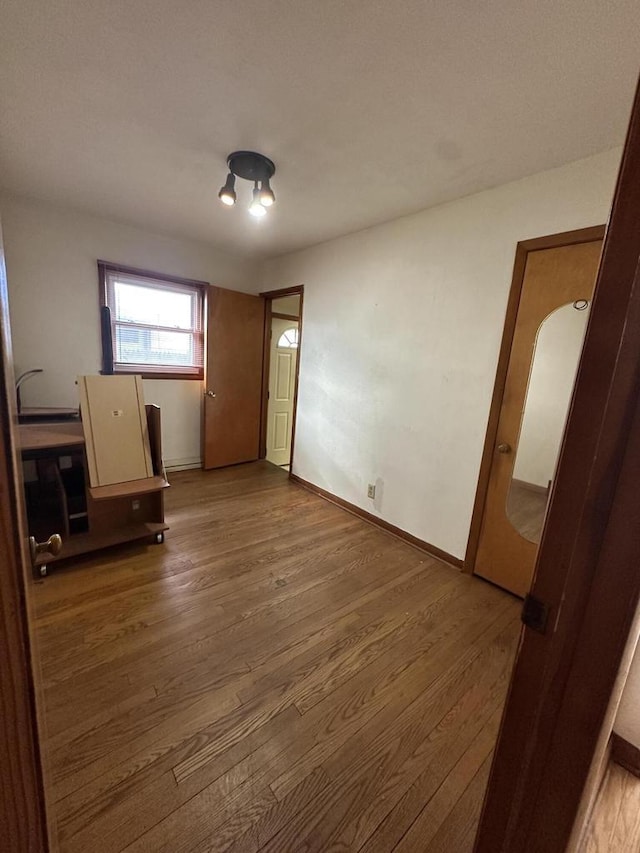 unfurnished bedroom featuring wood-type flooring