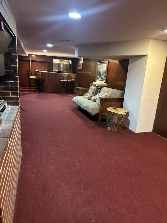 interior space featuring dark colored carpet and indoor bar