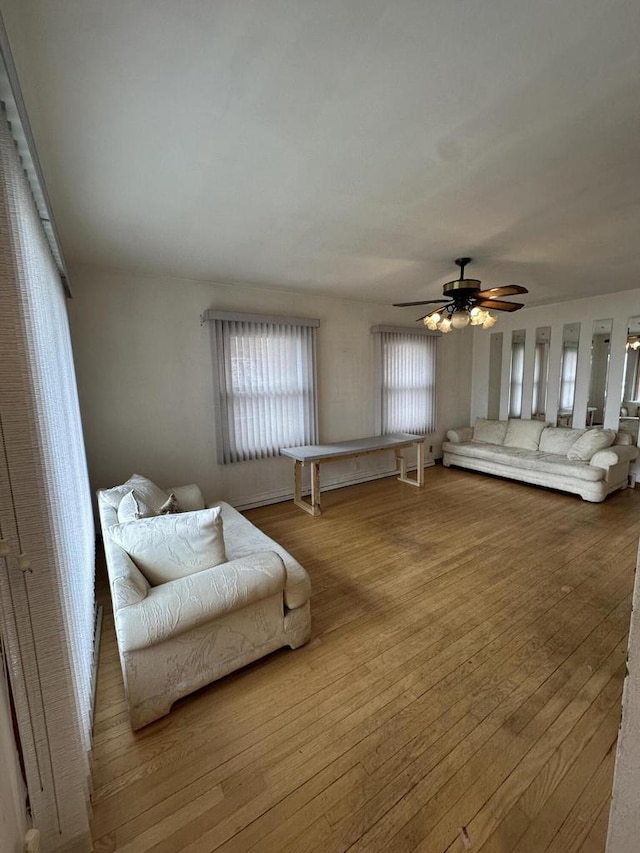 living room with ceiling fan and light wood-type flooring