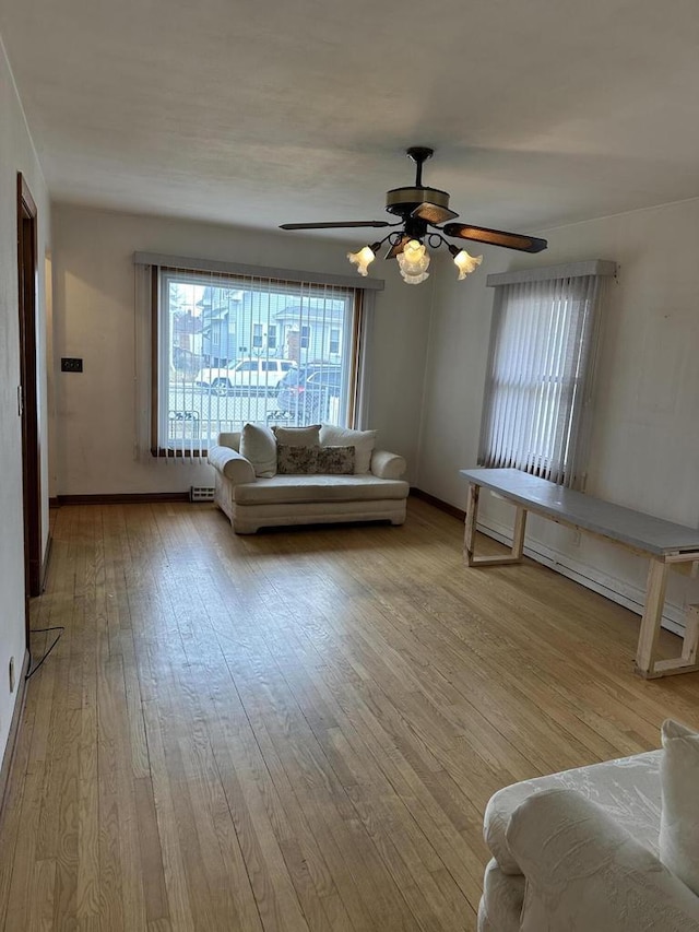 unfurnished living room featuring ceiling fan and light wood-type flooring