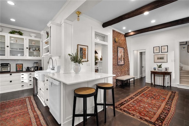 kitchen with white cabinetry, sink, white dishwasher, and beam ceiling