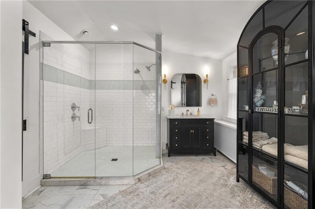 bathroom featuring vanity and an enclosed shower