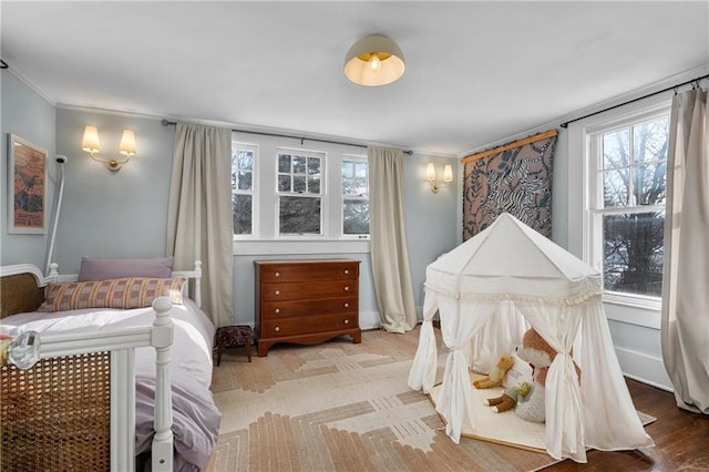 bedroom featuring multiple windows and ornamental molding