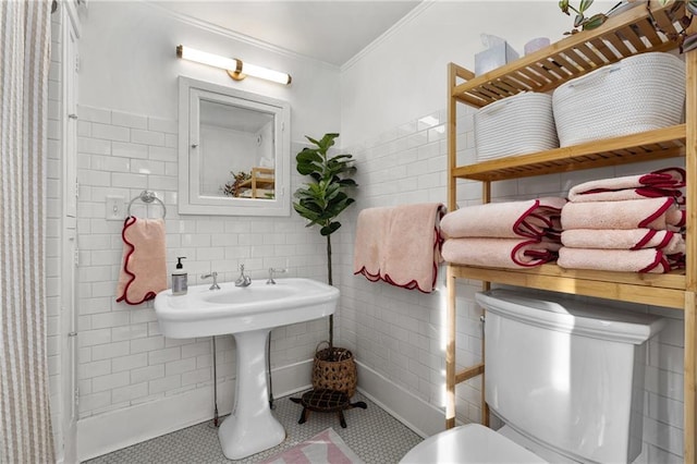 bathroom with ornamental molding, tile walls, and toilet