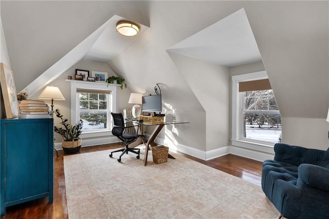 home office featuring vaulted ceiling and dark hardwood / wood-style floors