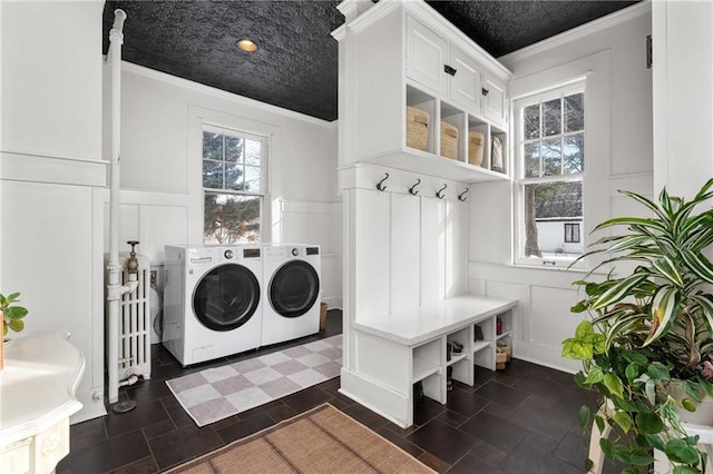 mudroom with crown molding and washing machine and clothes dryer