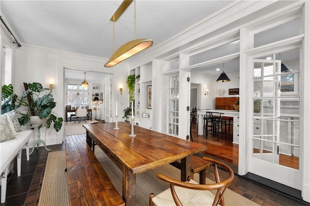 dining space featuring crown molding and dark hardwood / wood-style flooring