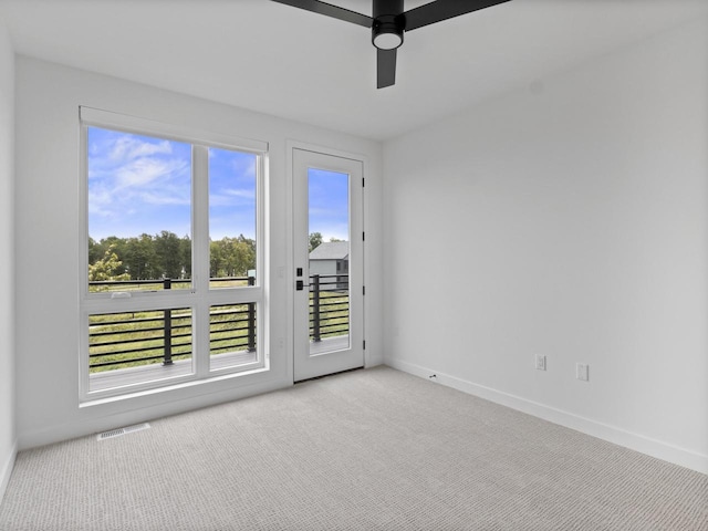 carpeted spare room with ceiling fan