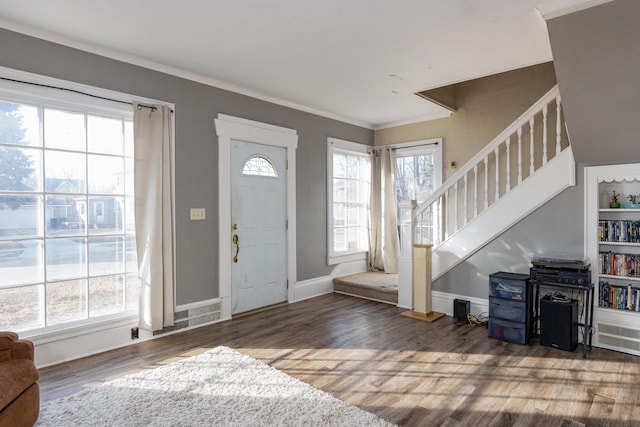 entryway with crown molding and dark hardwood / wood-style flooring