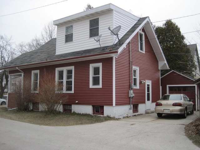 view of side of property featuring a garage and an outdoor structure