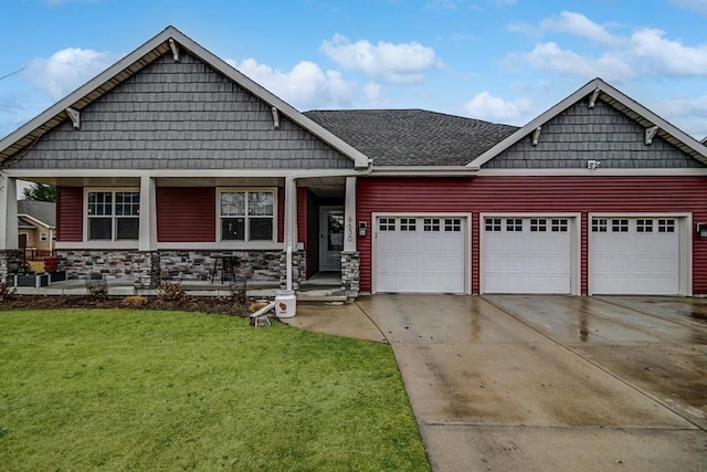 craftsman-style home featuring a garage and a front lawn