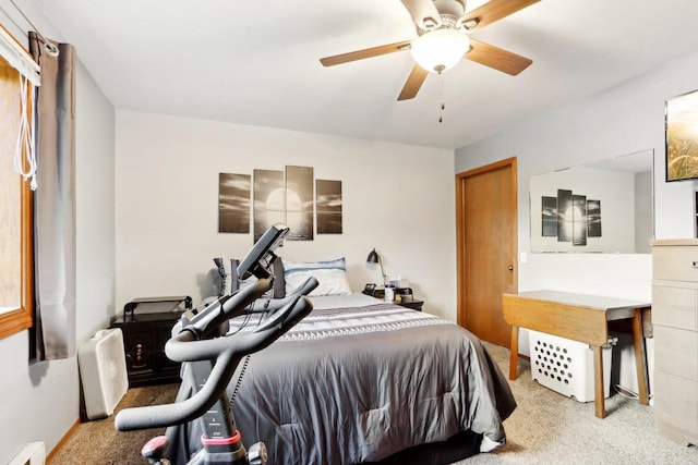 carpeted bedroom featuring ceiling fan and baseboard heating