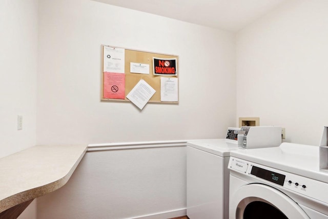 clothes washing area featuring washer and clothes dryer