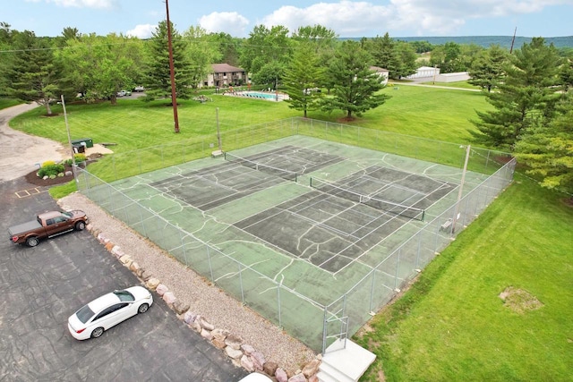 view of property's community featuring tennis court