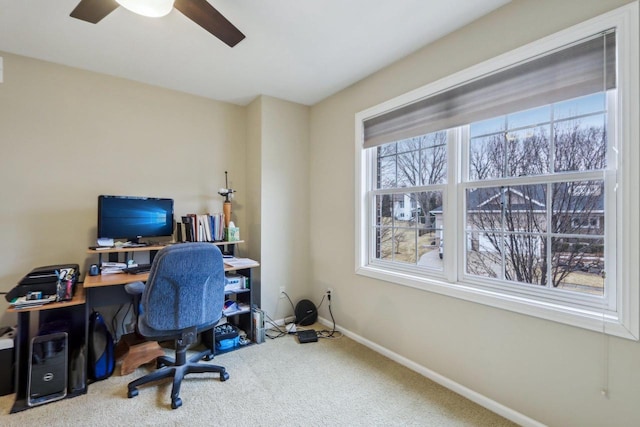 carpeted office featuring ceiling fan