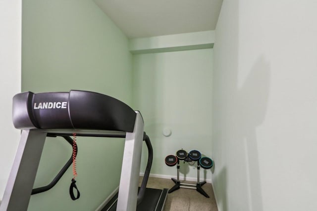 exercise room featuring carpet flooring and vaulted ceiling