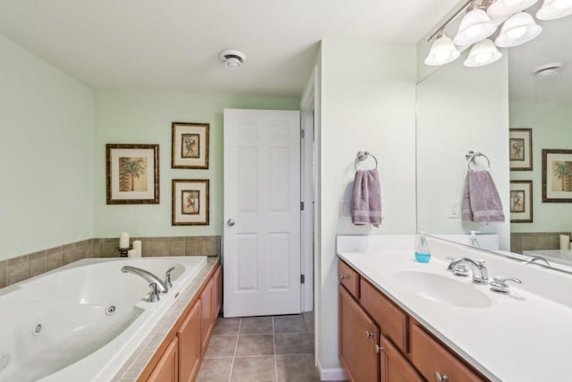 bathroom with tiled tub, vanity, and tile patterned floors