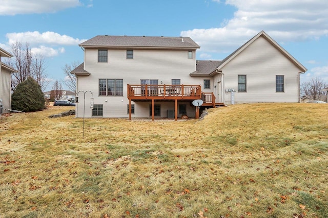 back of house featuring a yard and a deck