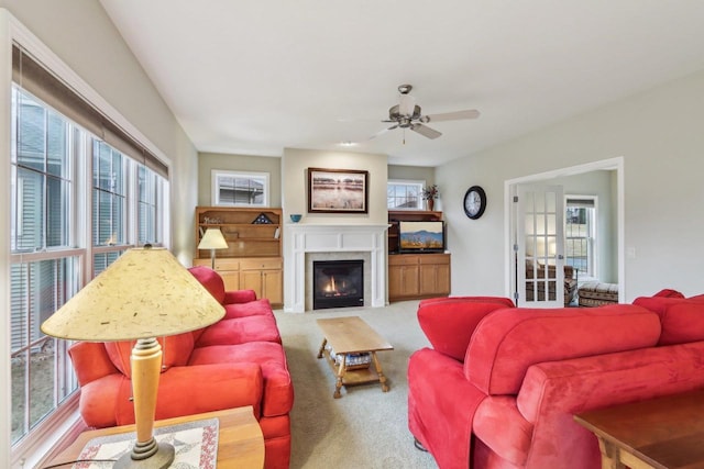 carpeted living room with ceiling fan