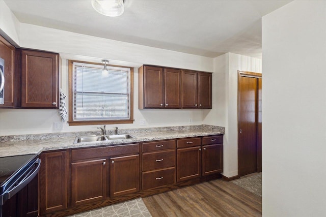 kitchen featuring sink, dark wood-type flooring, black range with electric cooktop, and dark brown cabinets