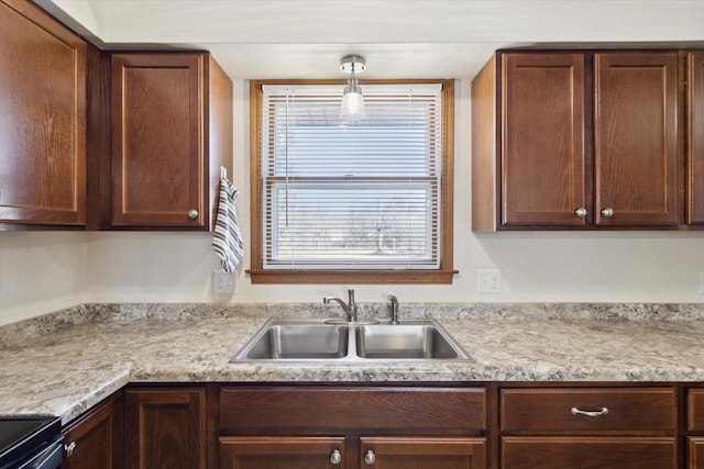 kitchen featuring sink, electric range, and hanging light fixtures