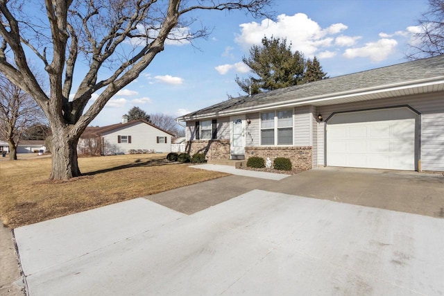 ranch-style home featuring a garage and a front lawn